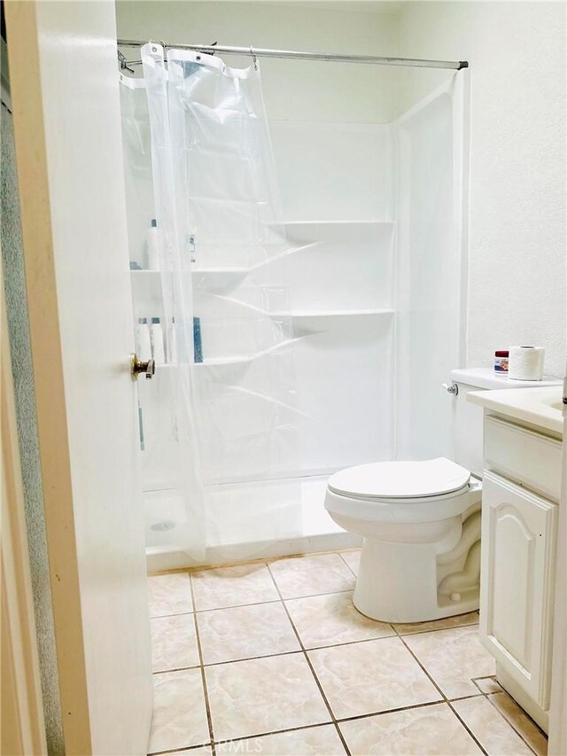 10907 Bartlett, Adelanto, CA 92301 - bathroom with vanity, curtained shower, toilet, and tile patterned floors
