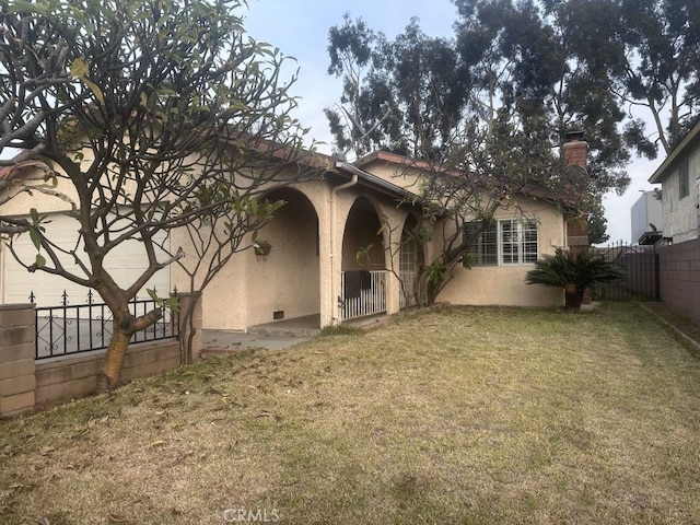 rear view of house featuring a yard