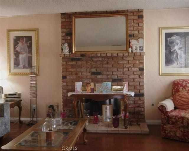 living room featuring dark hardwood / wood-style flooring and a textured ceiling