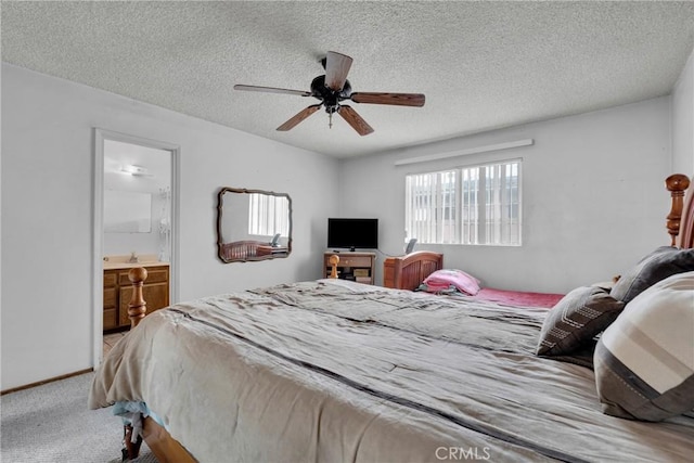 carpeted bedroom with connected bathroom, a textured ceiling, and ceiling fan