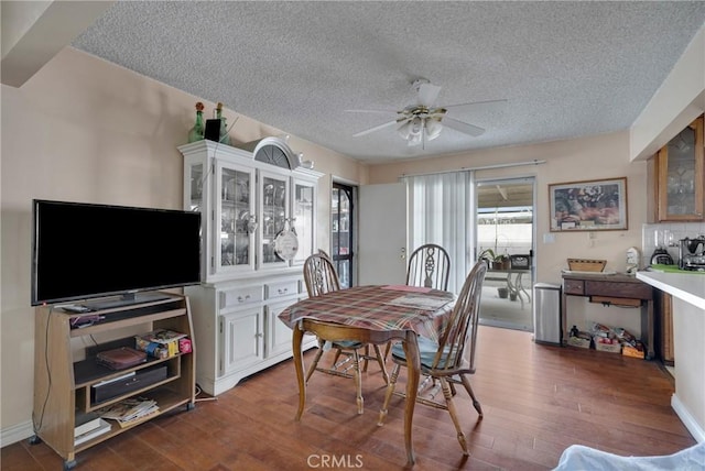 dining space with ceiling fan, hardwood / wood-style flooring, and a textured ceiling