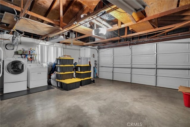 garage with separate washer and dryer and a garage door opener