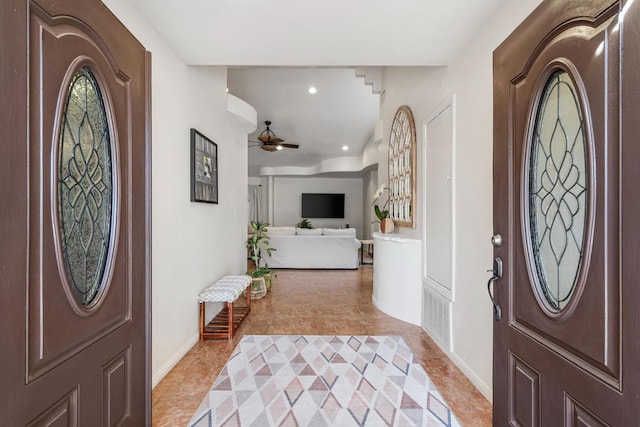 tiled foyer entrance with ceiling fan