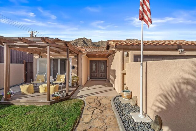 entrance to property featuring a pergola