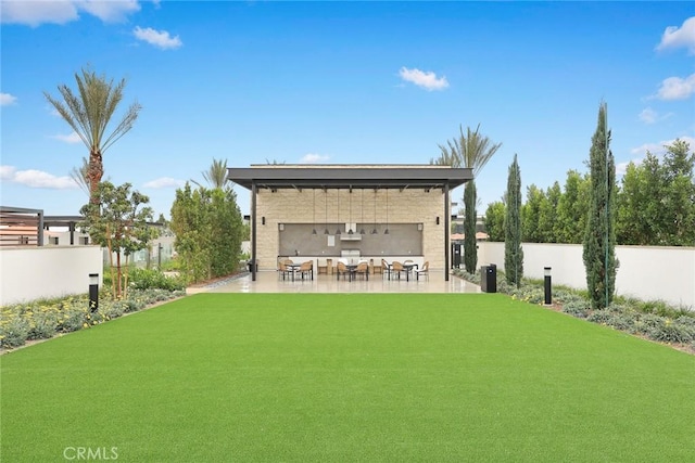 rear view of property with a patio area and a lawn