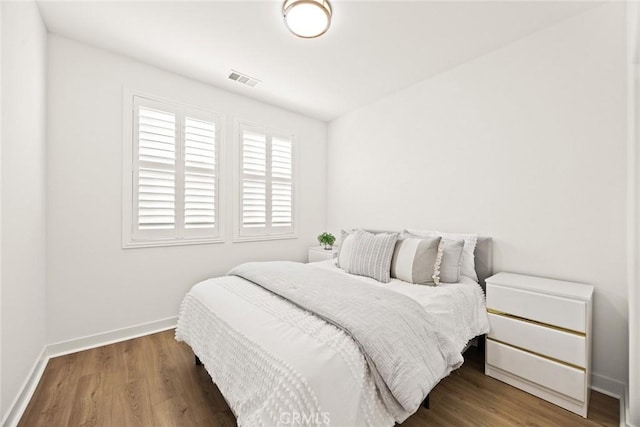 bedroom with hardwood / wood-style flooring