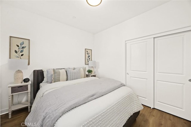 bedroom featuring dark hardwood / wood-style floors and a closet