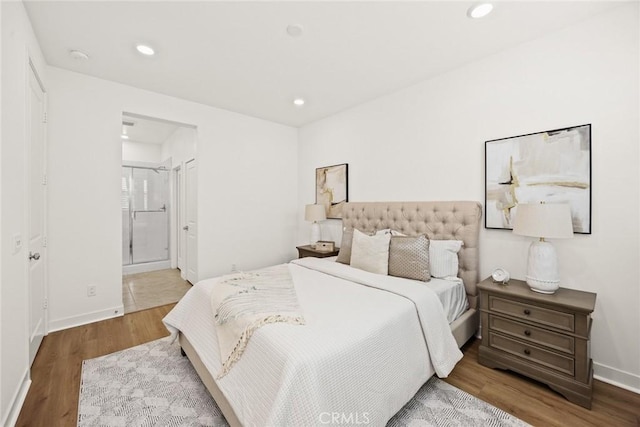 bedroom featuring wood-type flooring and connected bathroom