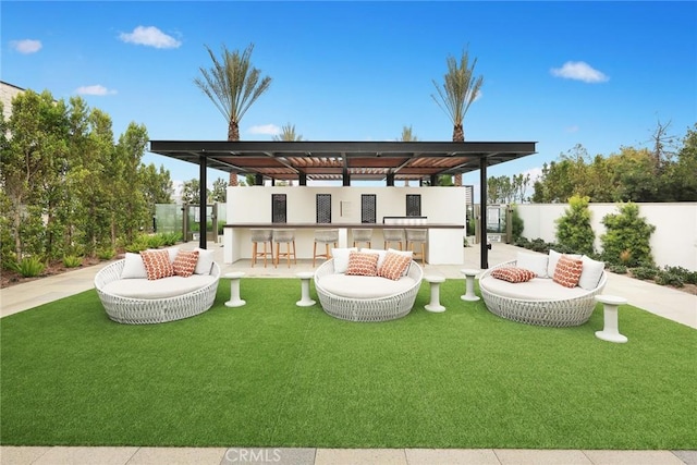 rear view of property with a patio area, outdoor lounge area, exterior bar, and a yard