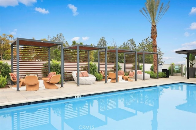 view of swimming pool with a pergola and a patio