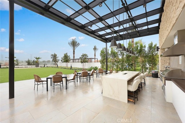 view of patio with grilling area, a bar, area for grilling, and a pergola