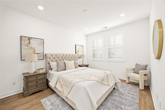 bedroom with visible vents, recessed lighting, light wood-type flooring, and baseboards