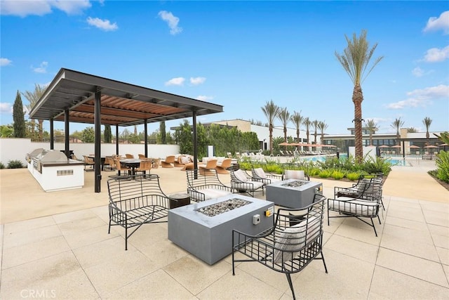 view of patio / terrace featuring an outdoor fire pit and a community pool