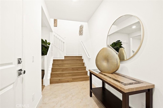 tiled foyer entrance featuring stairs