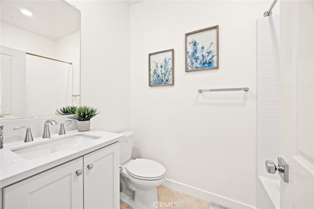 bathroom featuring toilet, vanity, and tile patterned flooring