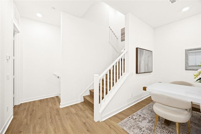 stairway featuring hardwood / wood-style floors