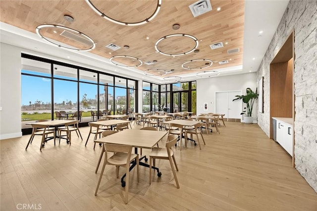 dining area featuring light hardwood / wood-style floors and wood ceiling