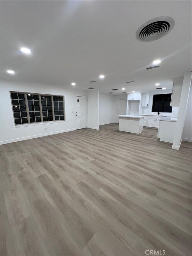 unfurnished living room with light hardwood / wood-style flooring