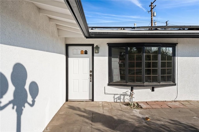 property entrance with a patio area