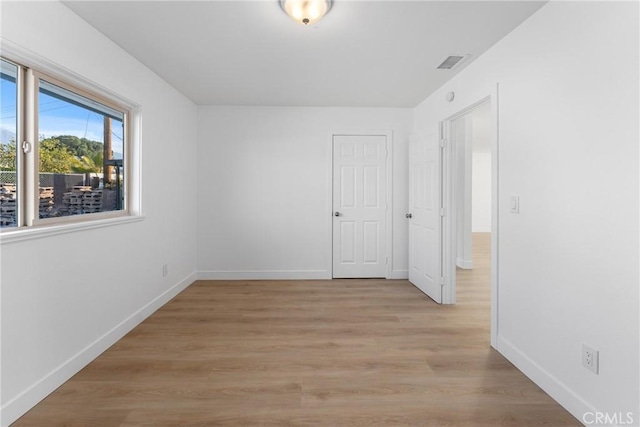 spare room with light hardwood / wood-style floors