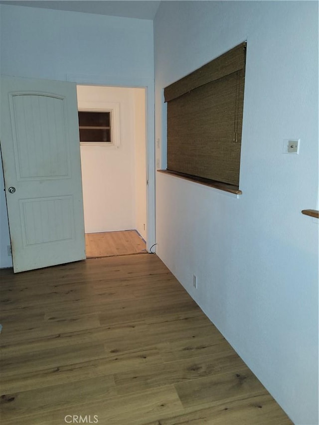 corridor with hardwood / wood-style floors