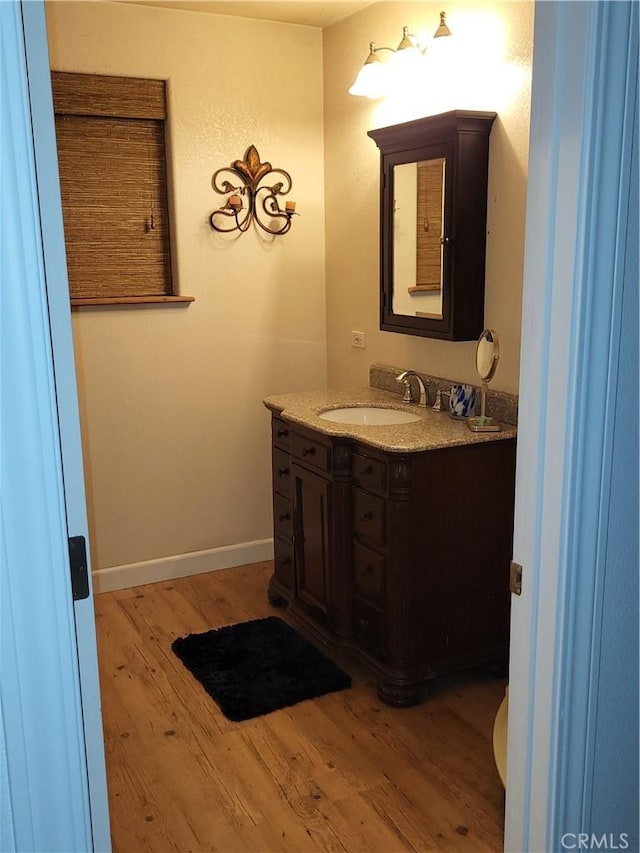 bathroom featuring vanity and hardwood / wood-style flooring