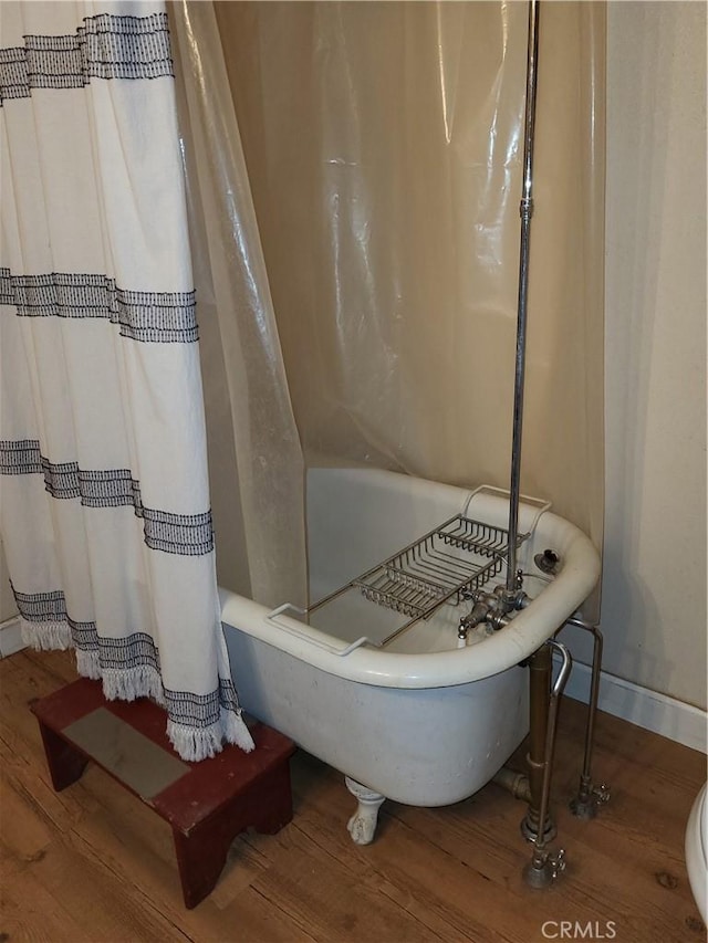 bathroom featuring shower / bath combo and wood-type flooring