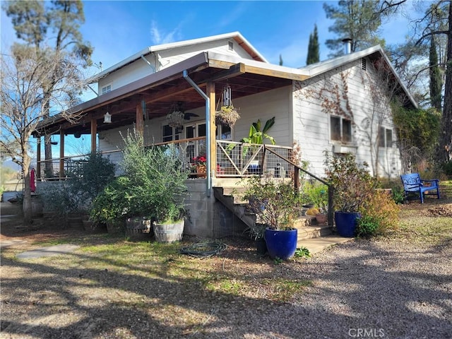 view of property exterior with ceiling fan and a porch