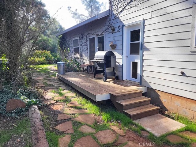 wooden terrace featuring area for grilling