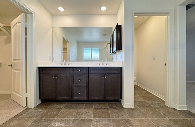 bathroom featuring toilet and vanity