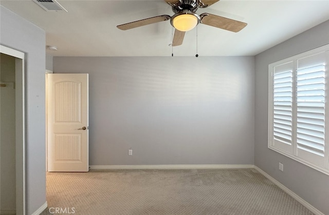 carpeted empty room featuring ceiling fan