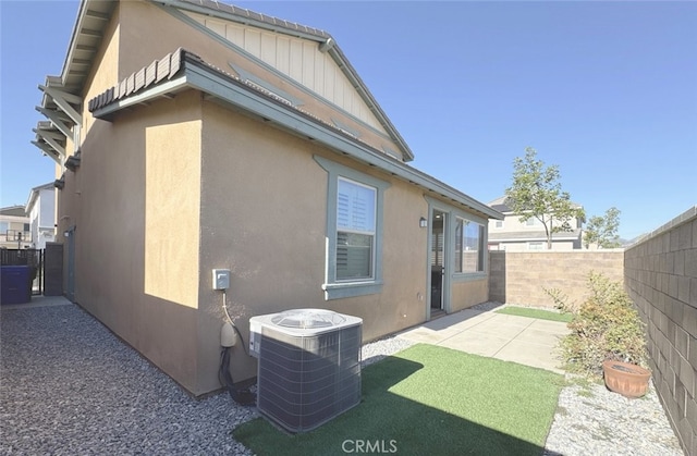 rear view of house with cooling unit and a patio