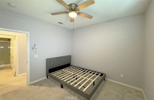 bedroom featuring ceiling fan and light colored carpet