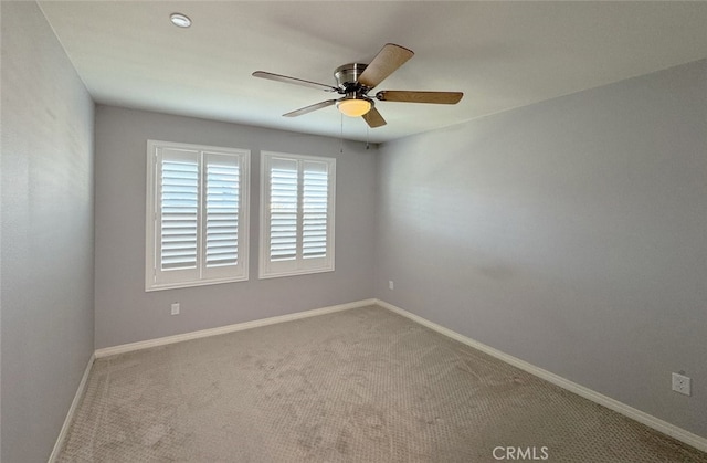 carpeted empty room featuring ceiling fan