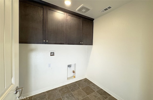 washroom with hookup for a gas dryer, hookup for an electric dryer, hookup for a washing machine, and cabinets