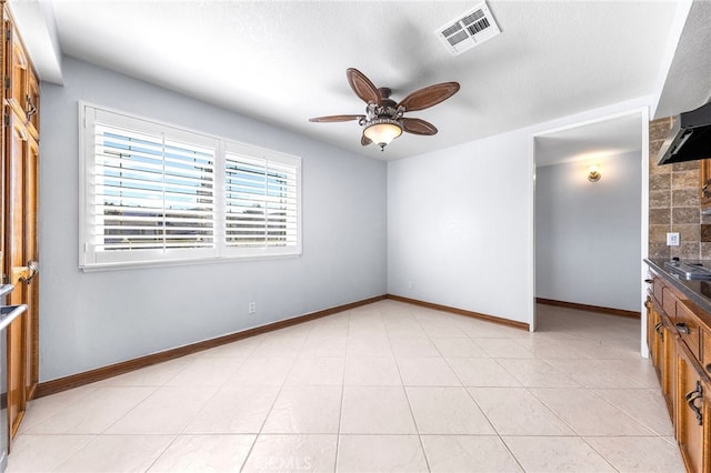 interior space with ceiling fan