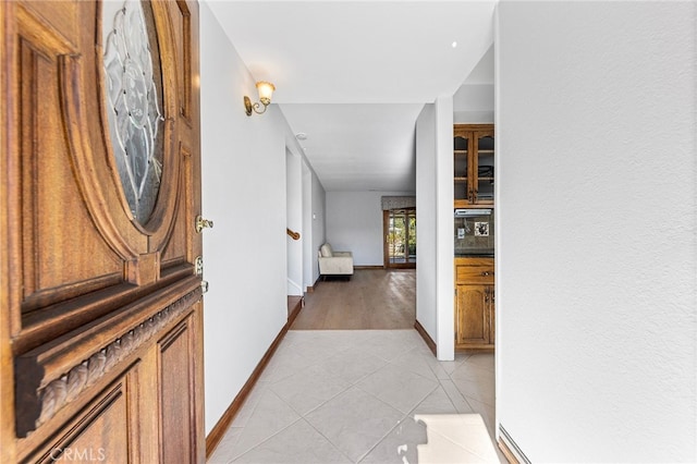 hall with light tile patterned floors