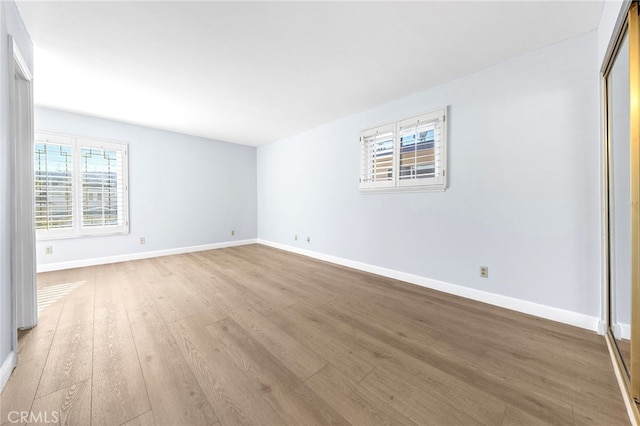 empty room featuring light hardwood / wood-style flooring and a wealth of natural light