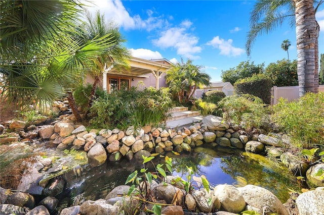 view of yard featuring a garden pond