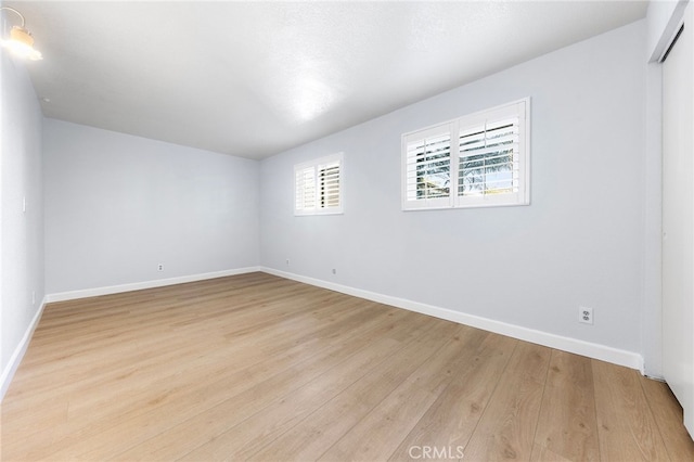 unfurnished room with light wood-type flooring