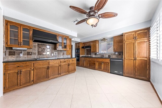 kitchen with sink, plenty of natural light, decorative backsplash, exhaust hood, and black appliances