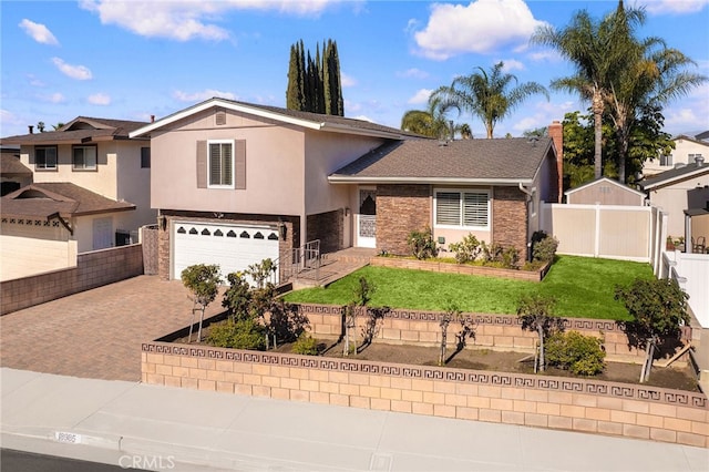 view of front of property featuring a front lawn and a garage