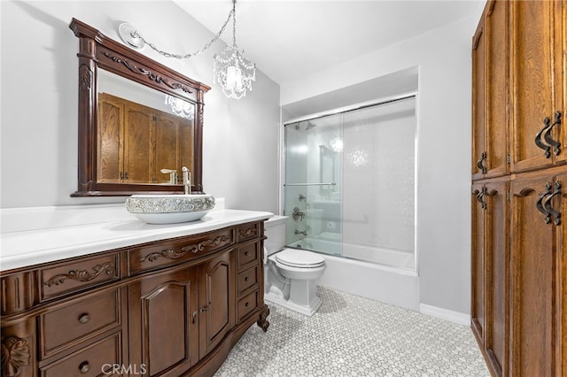 full bathroom featuring toilet, a notable chandelier, tile patterned floors, enclosed tub / shower combo, and vanity