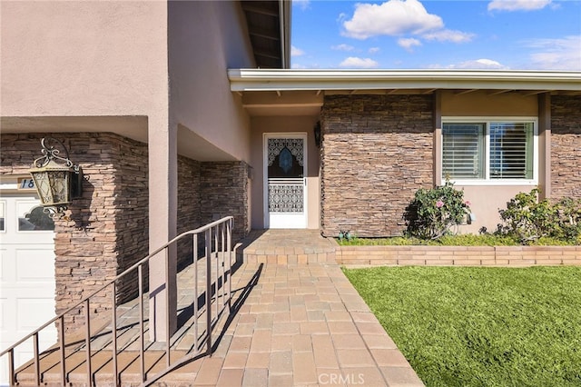 doorway to property featuring a garage and a lawn