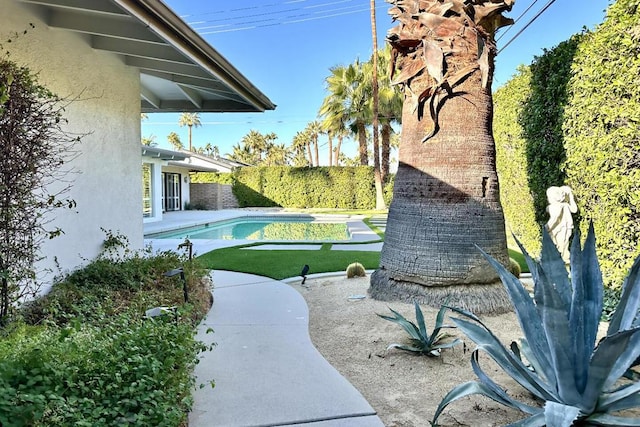 exterior space with a patio area and a fenced in pool