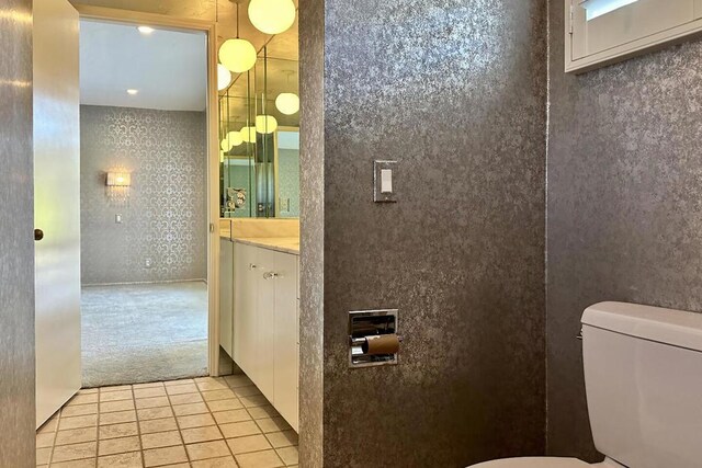 bathroom featuring toilet, vanity, and tile patterned flooring