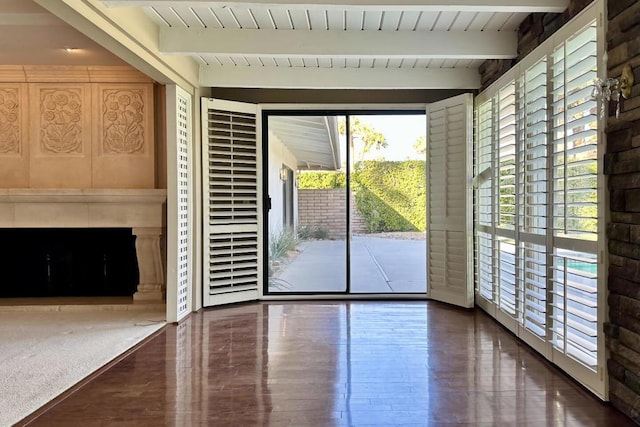 doorway to outside with beam ceiling