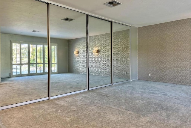 unfurnished bedroom featuring a closet and carpet flooring