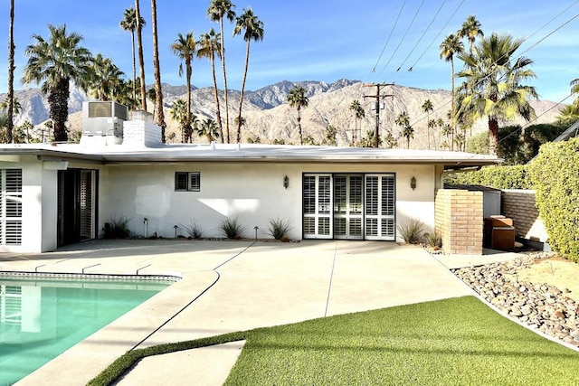 rear view of property with a patio area and a mountain view