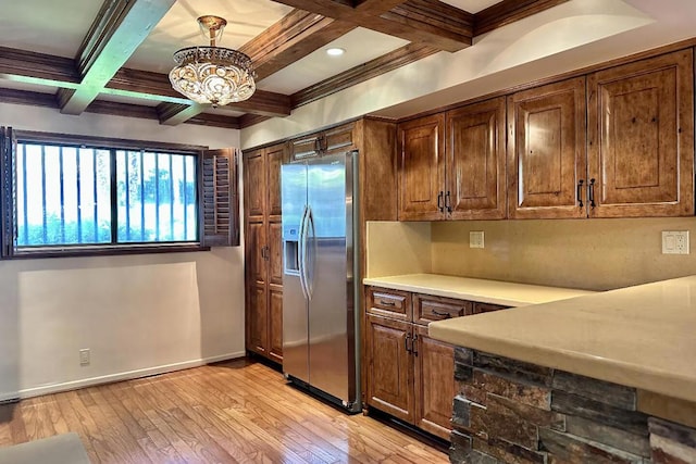 kitchen with stainless steel refrigerator with ice dispenser, decorative light fixtures, beamed ceiling, light wood-type flooring, and coffered ceiling